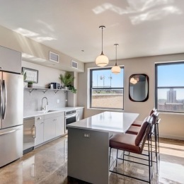 Elevate your evenings at the @thetellerhouseflats rooftop lounge!  a kitchen with an island