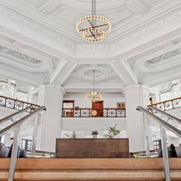 History meets modern elegance at @thetellerhouseflats . a large room with a chandelier
